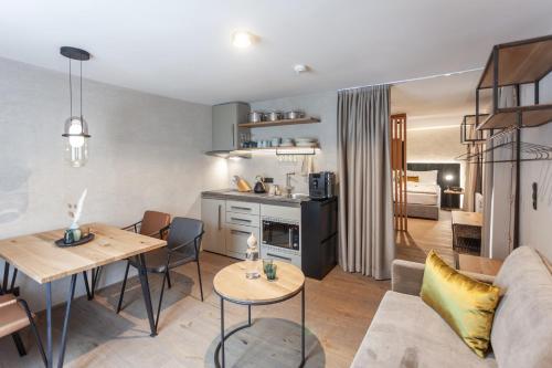 a living room with a couch and a table at Glanz & Glory Appartements Sölden in Sölden