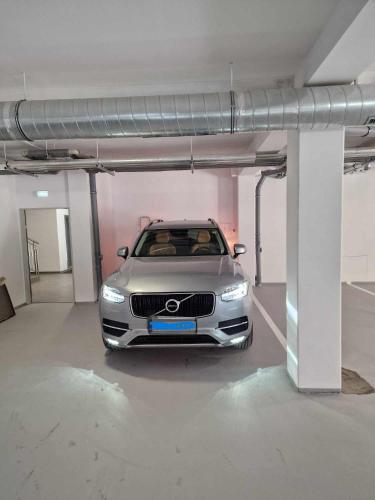 a silver car parked in a parking lot at Miner's Lodge in Jáchymov
