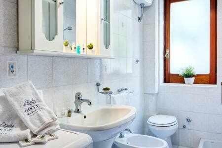 a white bathroom with a sink and a toilet at GOCCE VILLAS - Casa Maradona in Nerano