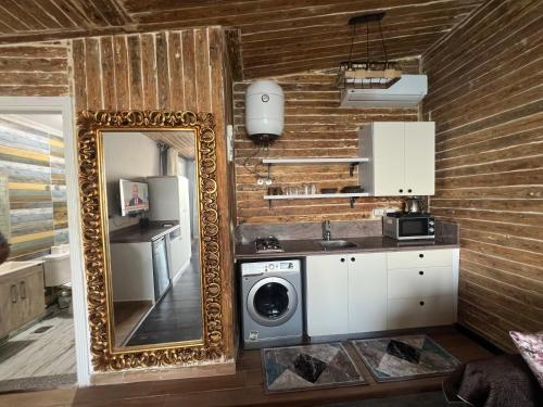 a kitchen with a washing machine and a mirror at Sea View Cabin in Alexandria