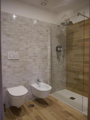 a bathroom with a toilet and a sink and a shower at VAGABONDO PETIT MAISON in Caserta