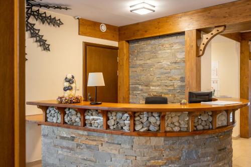 an office lobby with a stone wall at Dom Wczasowy Grań in Zakopane