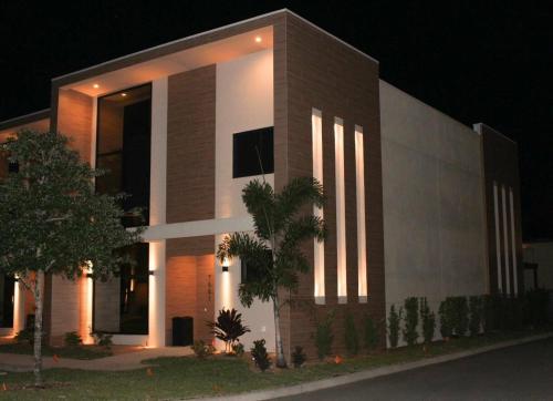 a building with lights on the side of it at night at 4 Suites - 5 min from Disney - w Jacuzzi 7557 in Orlando