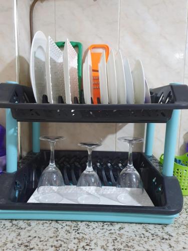 a knife rack with wine glasses and utensils at Chez Stef Taghazout in Taghazout