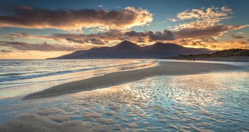a view of a beach with mountains in the background at Cosy barn conversion in the Mournes in Newry