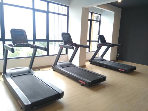 a group of treadmills in a gym with a window at Hann's Lodge in Putrajaya
