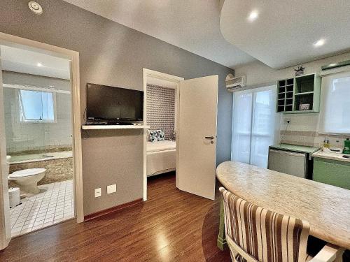a kitchen with a sink and a toilet and a counter at Flat Funchal JK Limpeza Diária, Internet 300mb in Sao Paulo