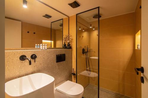 ein Badezimmer mit Waschbecken, Toilette und Dusche in der Unterkunft The Green Penthouse in Iraklio