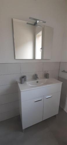 a bathroom with a white sink and a mirror at CASA NUOVA in Bee