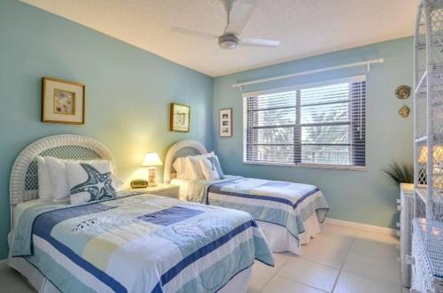 a bedroom with two beds and a window at Palms 309 in Islamorada
