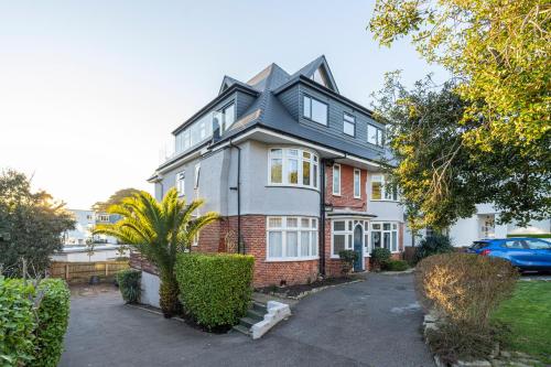 a house with a car parked in front of it at A Piece of Seaside Serenity on the Sandbanks Peninsula in Sandbanks