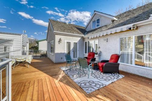a deck with chairs and tables on a house at First Place in Strathmore