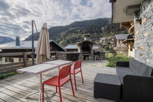a patio with a table and chairs and a fireplace at Chalet Alpin Luxe, Jacuzzi, Vue in Champagny-en-Vanoise