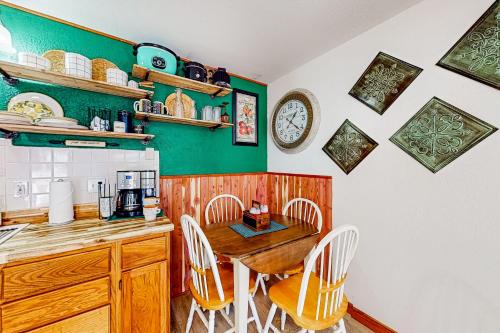 a kitchen with a wooden table and chairs at The Cove - Main House in Golden