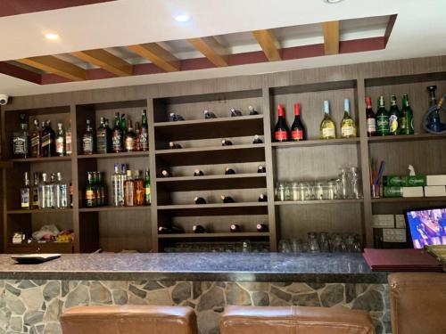 a bar with lots of bottles of alcohol at Rameshworam Hotel in Kathmandu
