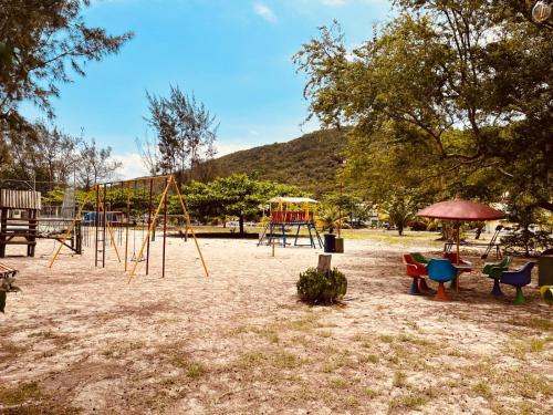 a park with a playground with a swing set at Apartamento em Ilha de Cabo Frio in Cabo Frio