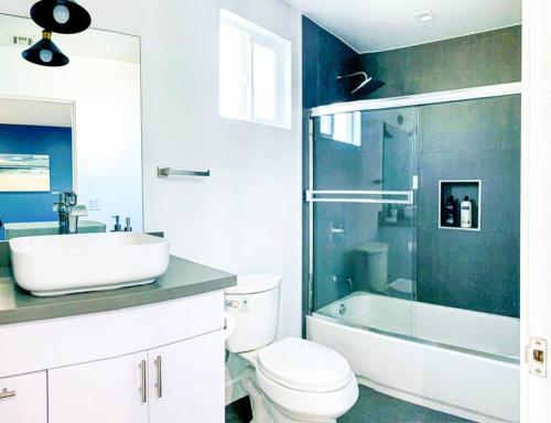 a bathroom with a toilet and a sink and a shower at Spacious Townhouse in Mid City - CR4-WIN in Los Angeles