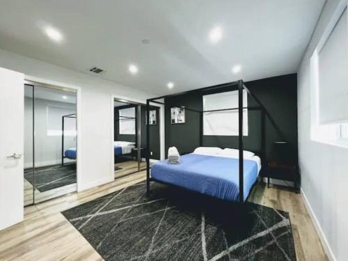a bedroom with a blue bed and a mirror at Ideal Townhouse in Mid City - CR1-CUL in Los Angeles