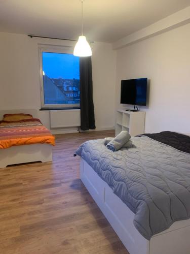 um quarto com uma cama e uma televisão de ecrã plano em Monteur- & Ferienwohnungen in Dorsten Altstadt - ZENTRUM - NEU saniert em Dorsten