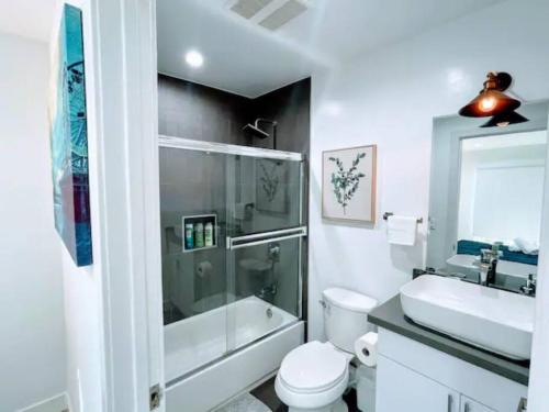 a bathroom with a shower and a toilet and a sink at Stylish Townhouse in Mid City - CR2-CUL in Los Angeles