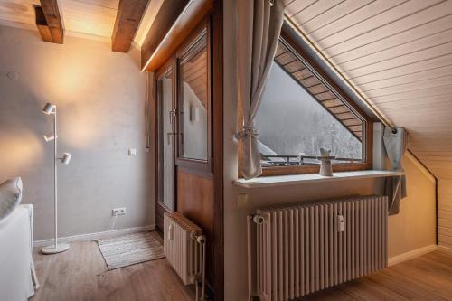 a bathroom with a window and a radiator and a sink at Köhlerstube Todtmoos in Todtmoos