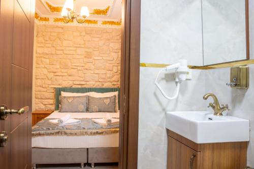 a bathroom with a sink and a bed at Sayina Hotel in Istanbul