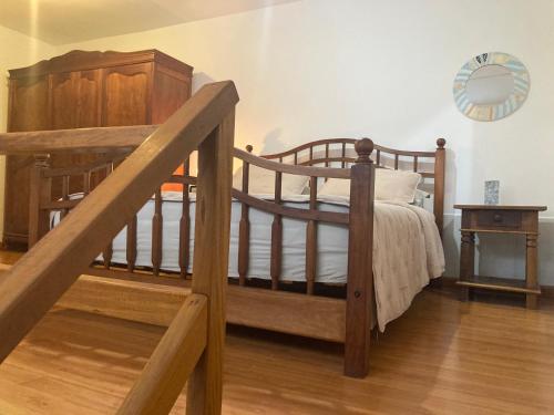 a bedroom with a wooden bunk bed and a staircase at Loft no Retiro in Brumadinho