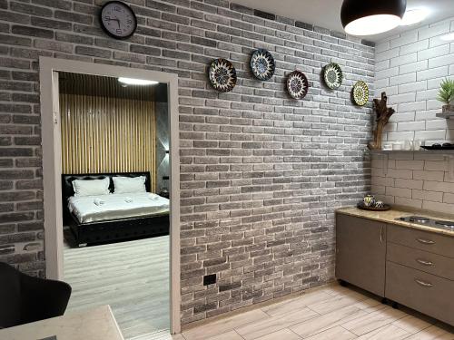 a room with a brick wall with a bed in it at Гостевой дом на Коктобе Люкс 4 in Almaty