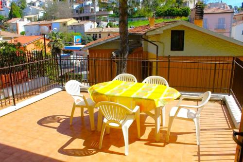 ヌマーナにあるOnda Bilo, con terrazza vista mare ed aria condizionataの黄色のテーブルと椅子が備わるバルコニー