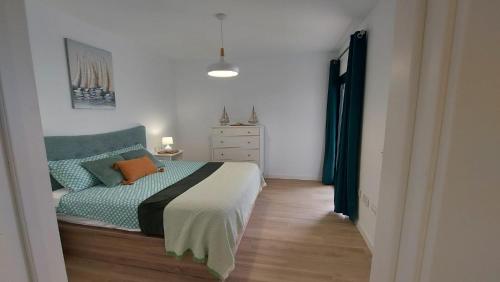 a bedroom with a bed and a dresser at Luxury Apartment in Casilla de Costa - Casa MEVA in Lajares
