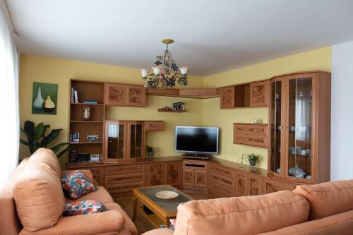 a living room with two couches and a flat screen tv at El Refugio de Eliseo in Haro