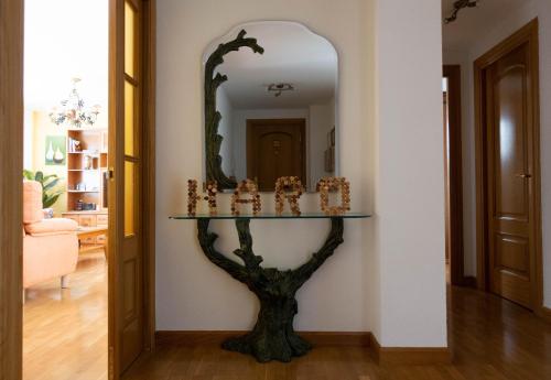 a mirror on a wall next to a table in a room at El Refugio de Eliseo in Haro