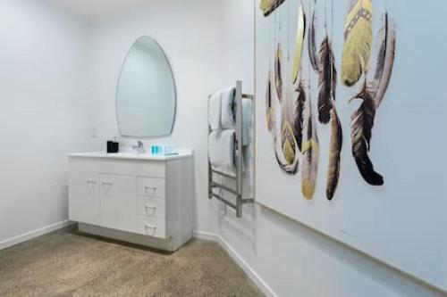 a bathroom with a sink and a mirror at Freeman Escape with garage parking in Auckland