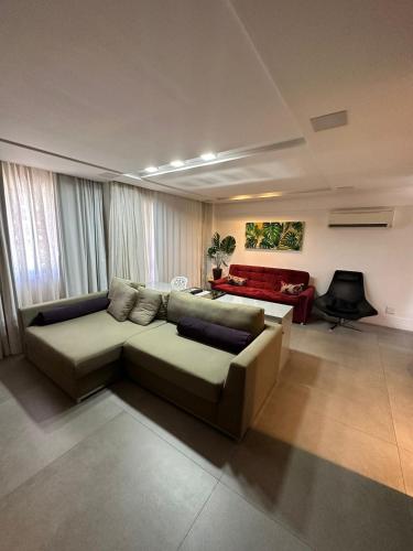 a living room with a couch and a pool table at Vip Meireles Beiramar Fortaleza HBM in Fortaleza