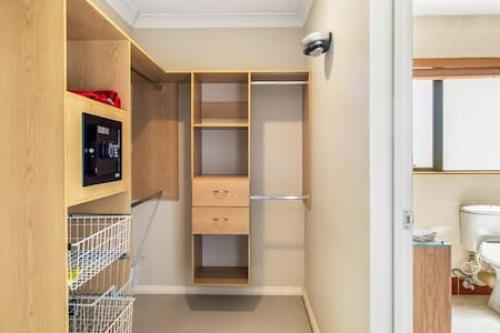 a small kitchen with a refrigerator in a room at Northpark Getaway with patio area in Auckland