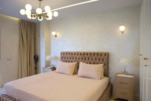 a bedroom with a large bed with two pillows at Villa Mogador By Solena in Essaouira