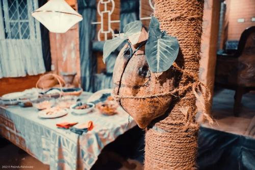a tree with a leaf on it next to a table at Samara Nature Paradise in Kalutara