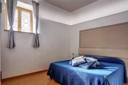 1 dormitorio con 1 cama azul en una habitación en Casa dellAccademia Apartment in Sorrento Centre, en Sorrento