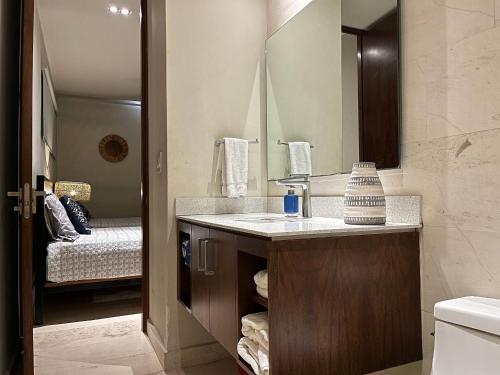 a bathroom with a sink and a mirror at Habitación Privada Riviera Maya, Playa del Carmen! in Playa del Carmen