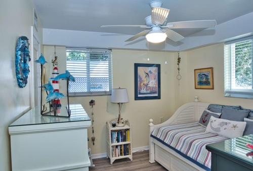 a bedroom with a bed and a ceiling fan at Parrot Eyes in Tavernier