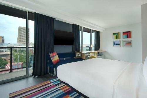 a hotel room with a bed and a large window at Aloft Oklahoma City Downtown – Bricktown in Oklahoma City
