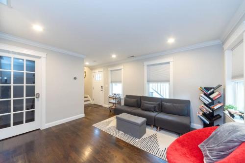 a living room with a couch and a red rug at Ultra-Luxurious Home near Boston (Pet-Friendly) in Waltham