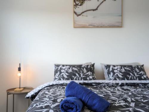 a blue towel is sitting on a bed at Serenity at Stromlo 2bd 1br at Wright in Weston Creek