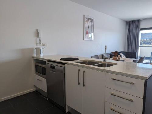 a kitchen with a sink and a counter top at Serenity at Stromlo 2bd 1br at Wright in Weston Creek