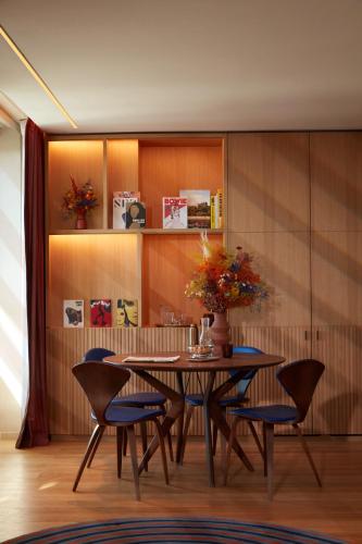 a dining room with a table and chairs at SO/ Paris Hotel in Paris