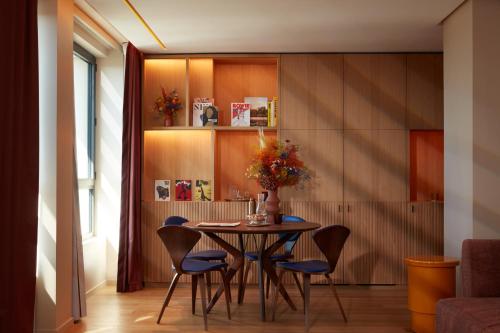 a dining room with a table and chairs at SO/ Paris Hotel in Paris
