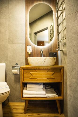 a bathroom with a sink and a mirror at Zatyshok nad Prutom in Bukovel