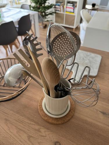 a container filled with kitchen utensils on a table at Appartement de charme hypercentre in Brest