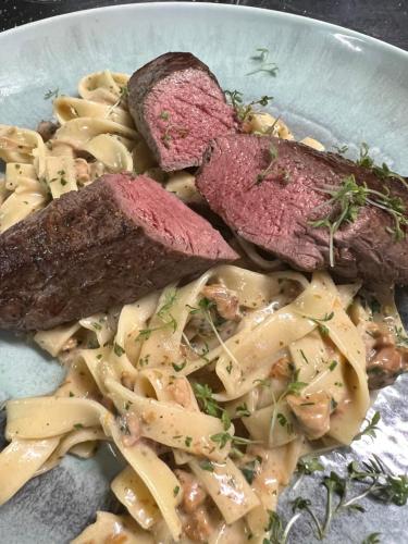 a plate of food with meat and pasta at Gasthof Seelhofer in Prigglitz