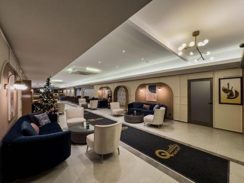 a hotel lobby with couches and a christmas tree at Quality Gold Suite Hotel in Antalya
